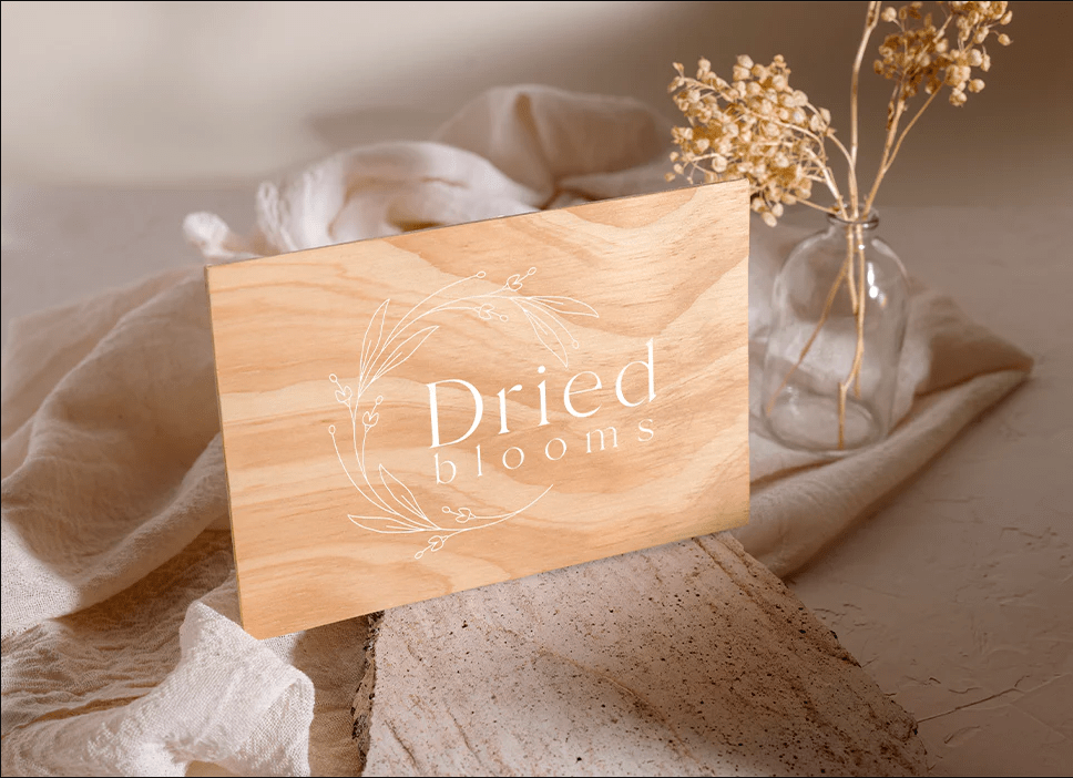 Dried Bloom logo on a light wooden card