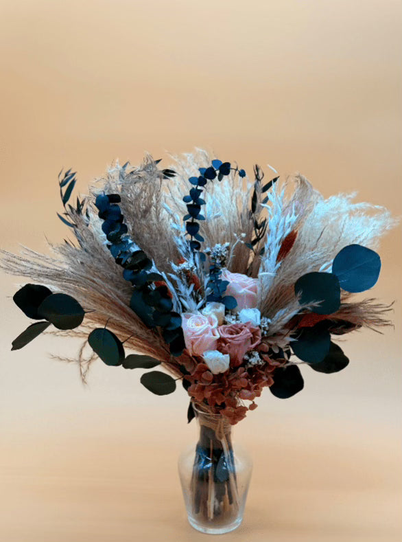 Bouquet of flowers in a clear vase on a beige background