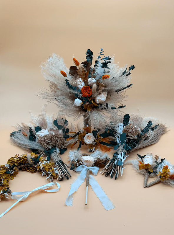 Collection of floral arrangements and accessories on a beige background