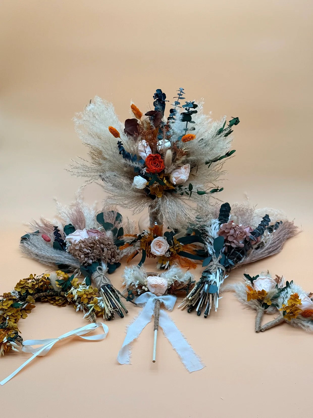 Collection of dried floral arrangements on a beige background