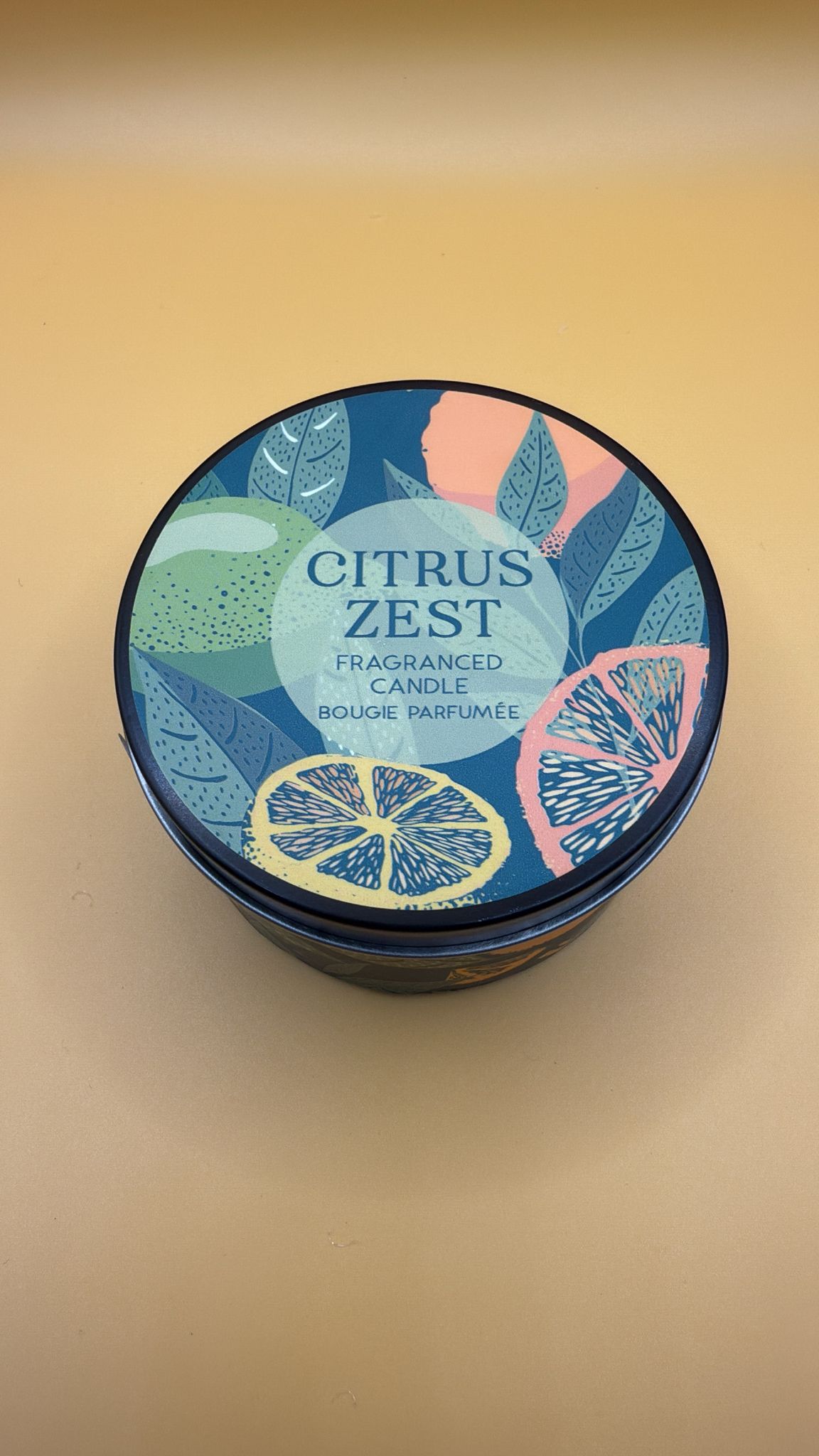 Citrus Zest scented candle container on a beige background