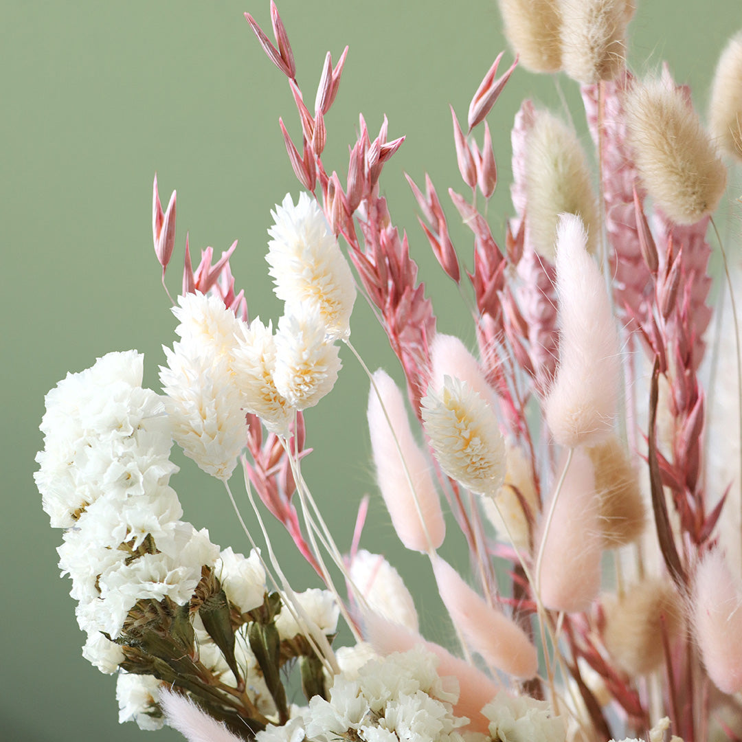 Bouquet of white and pink flowers with a green background