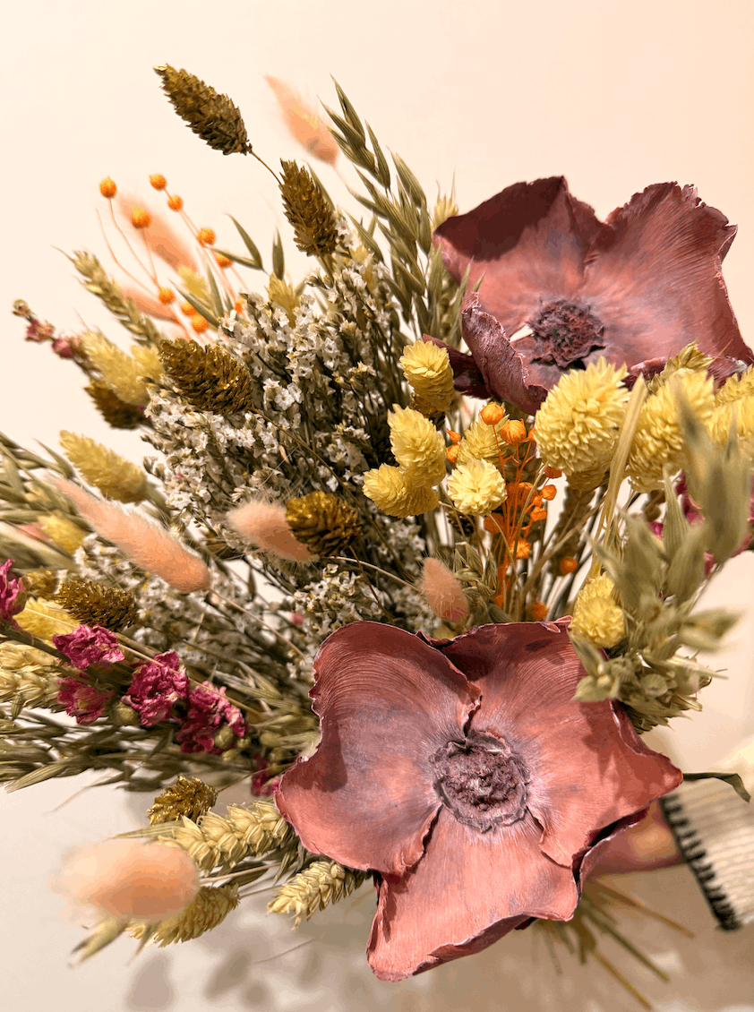 Bouquet of dried flowers with pink and yellow tones on a neutral background