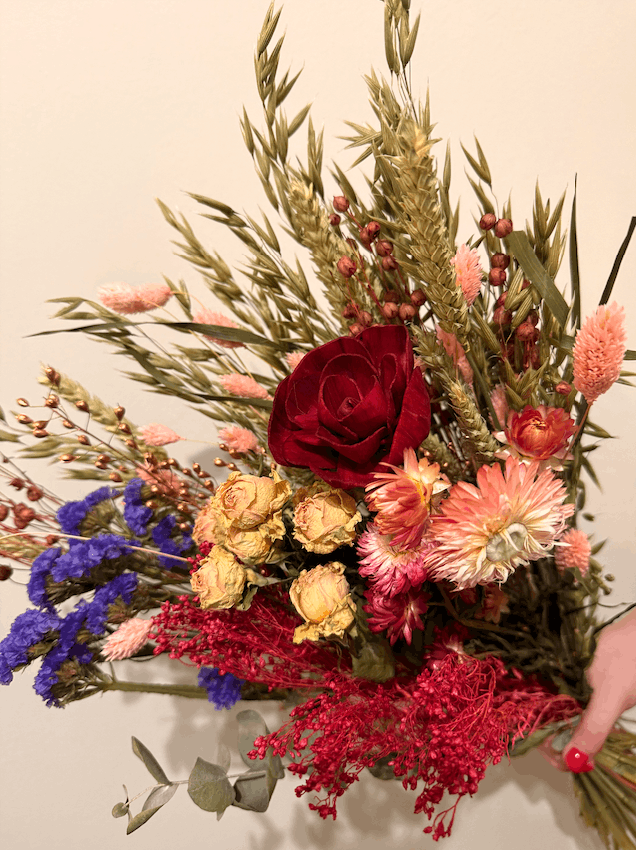 Bouquet of colorful flowers with a red rose on a neutral background