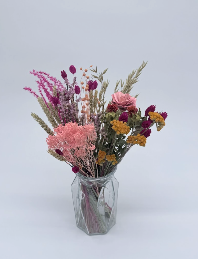 Dried Flower Bouquet with pink and yellow flowers and mixed stems in a geometric glass vase
