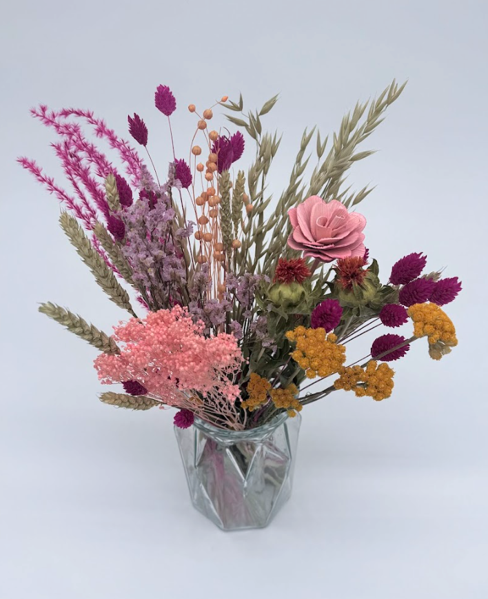 Dried Flower Bouquet with pink and yellow flowers and mixed stems in a geometric glass vase