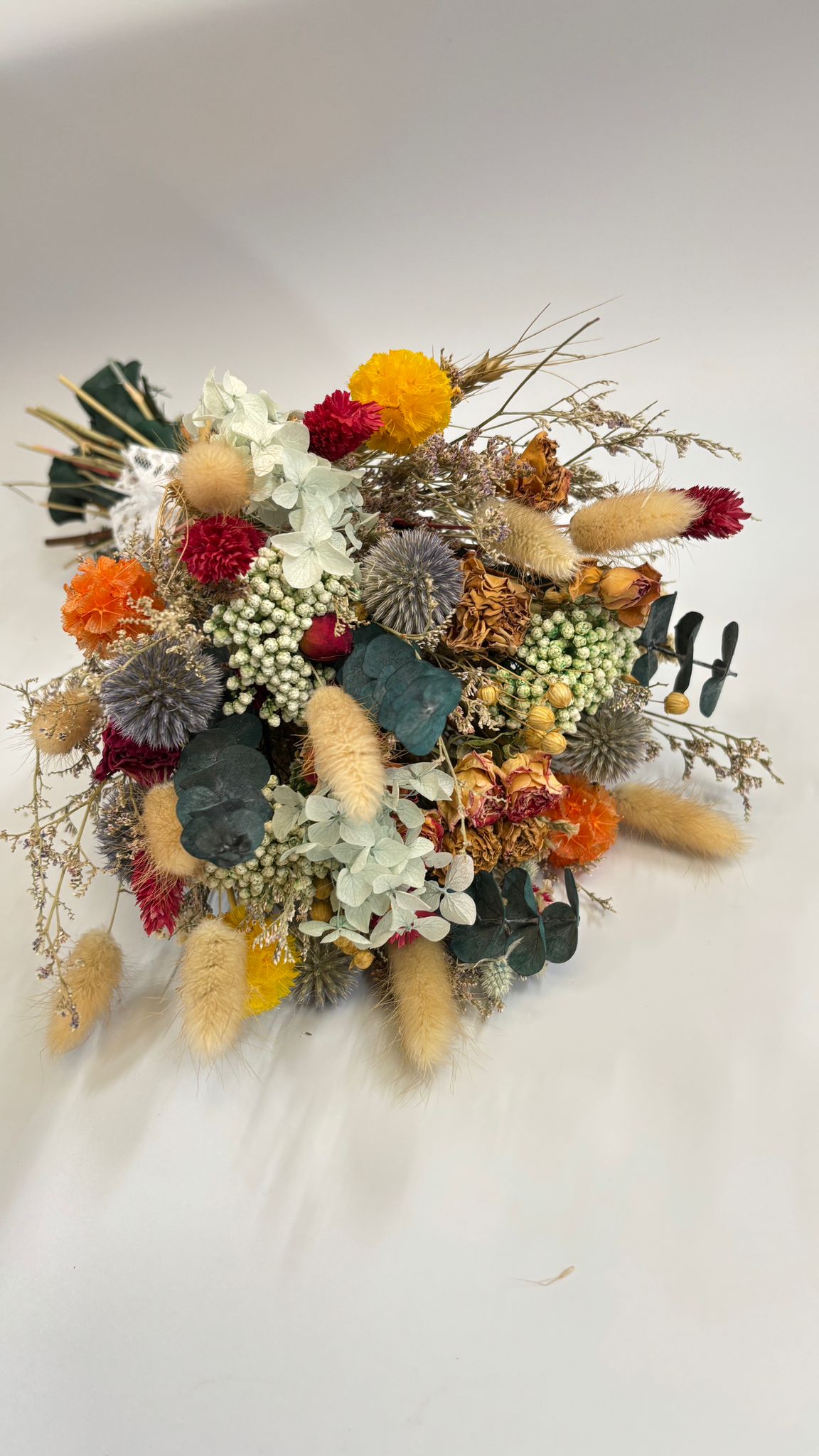 Colorful dried flower arrangement on a white background