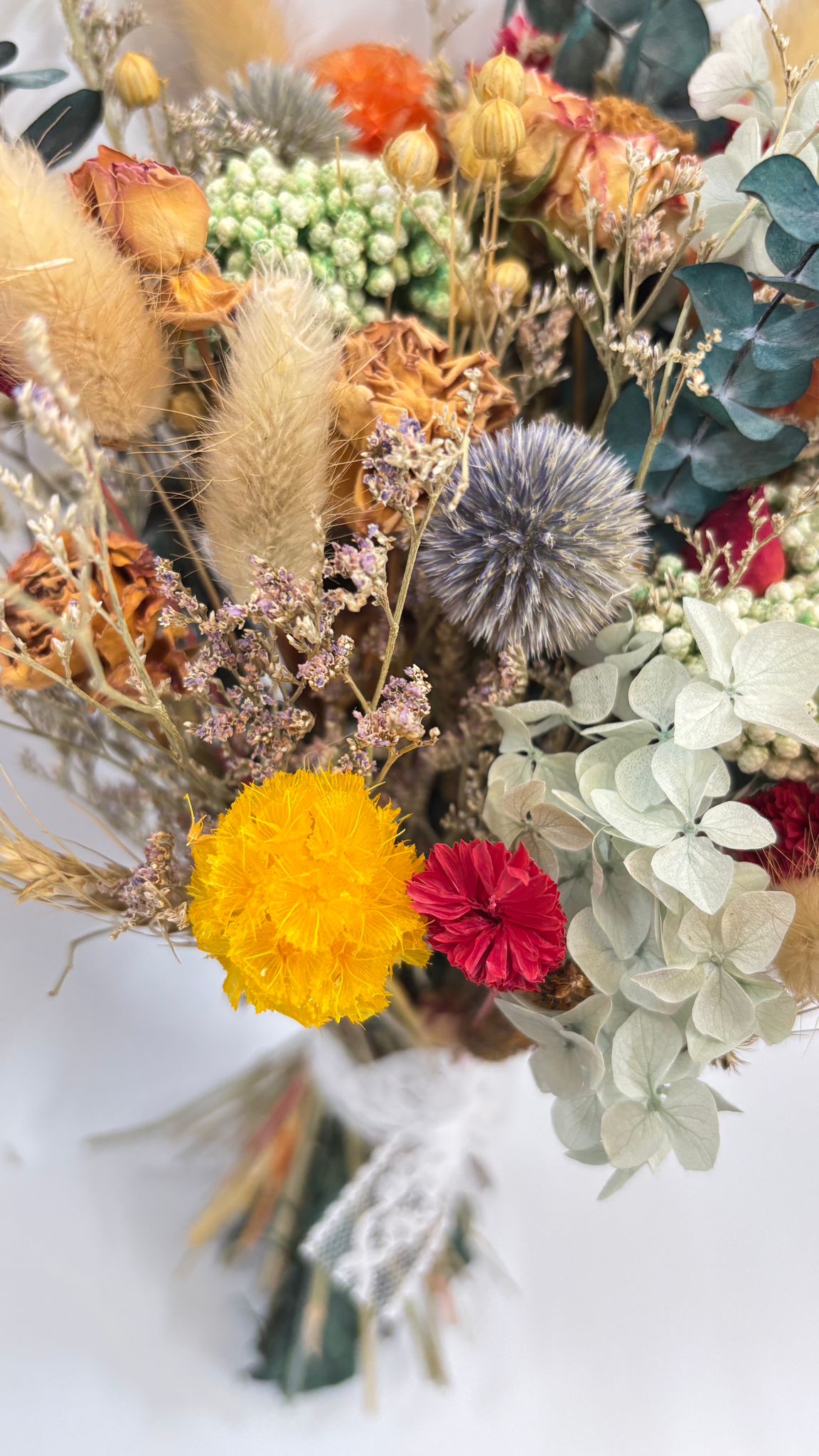 Bouquet of dried and fresh flowers on a white background