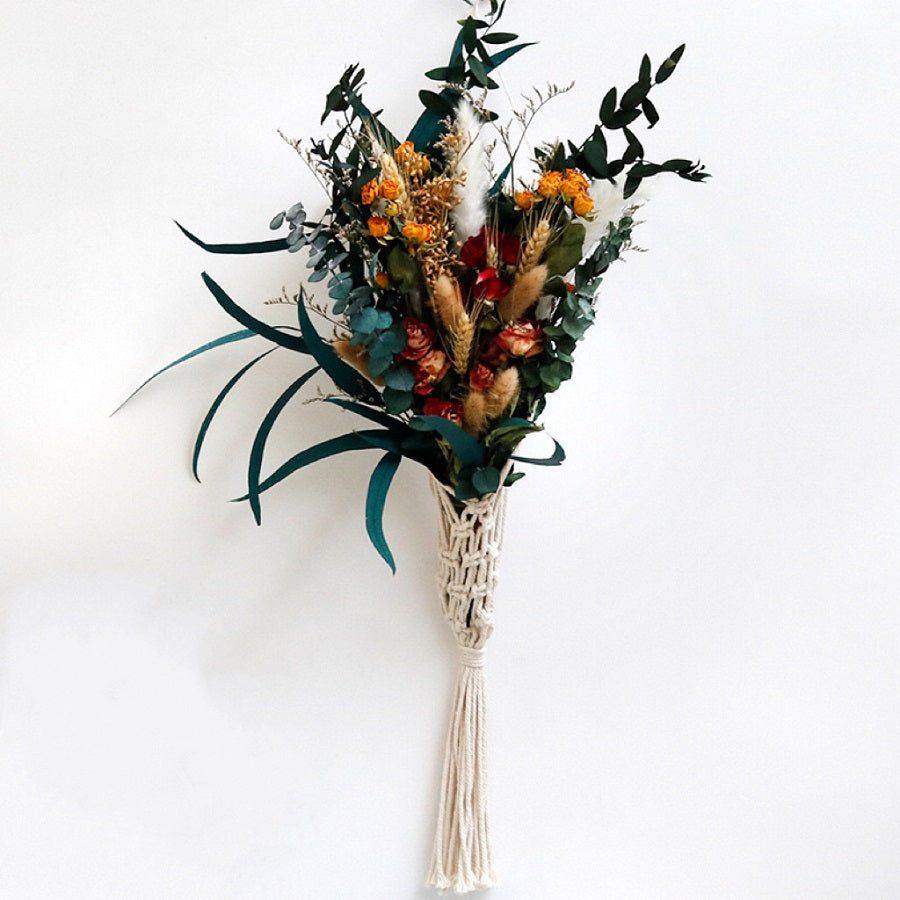 Bouquet of dried flowers with a macrame holder on a white background