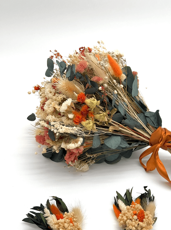 Bouquet of dried flowers with an orange ribbon on a white background