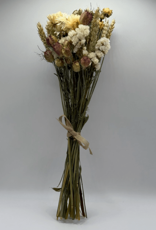 Bouquet of dried flowers tied with twine on a gray background