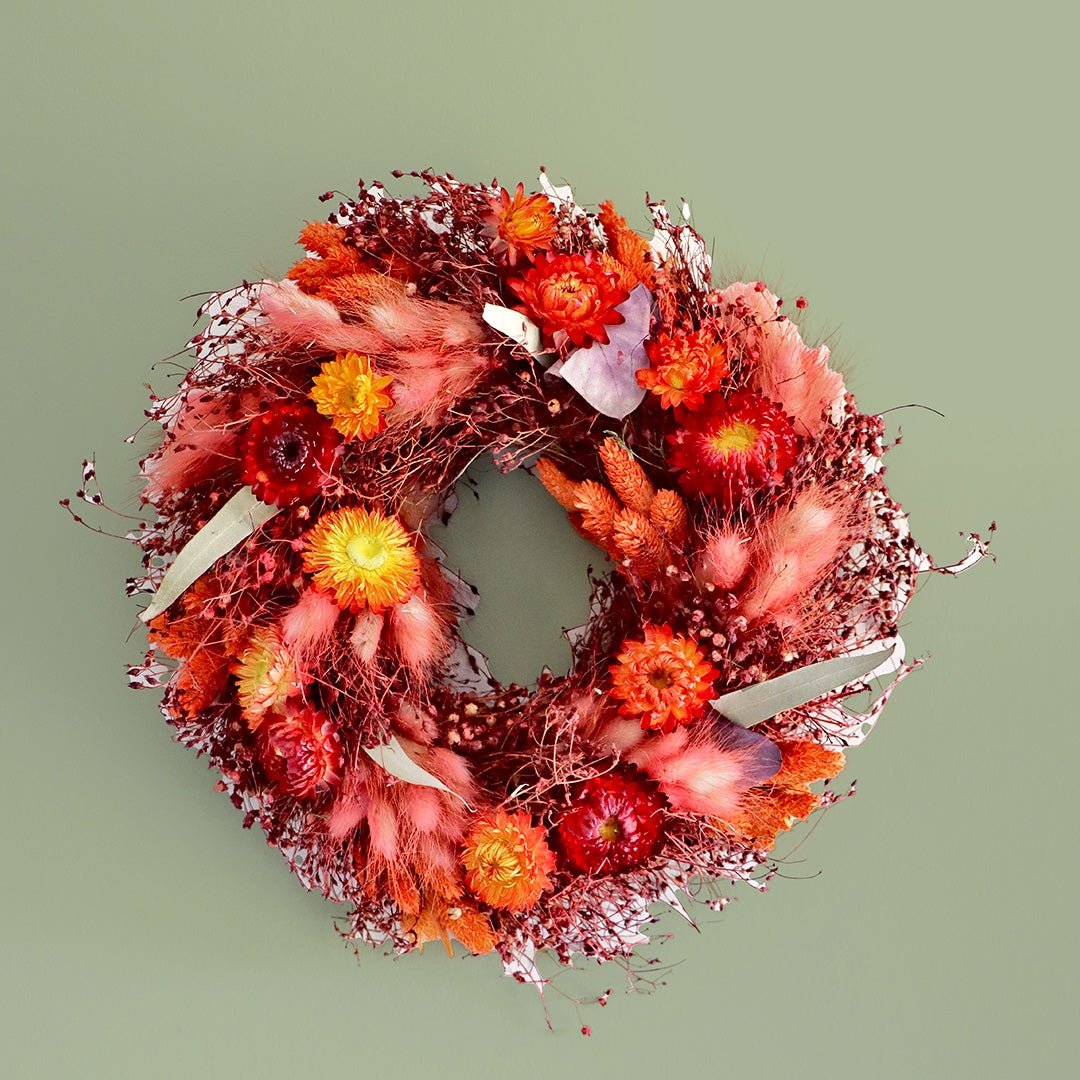 Decorative wreath with autumnal colors on a green background