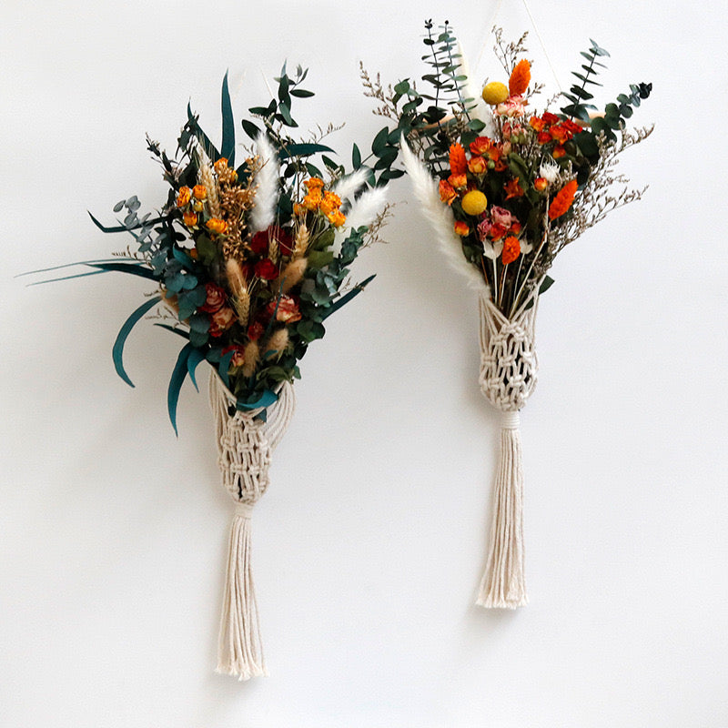 Two floral bouquets with macrame holders on a white background