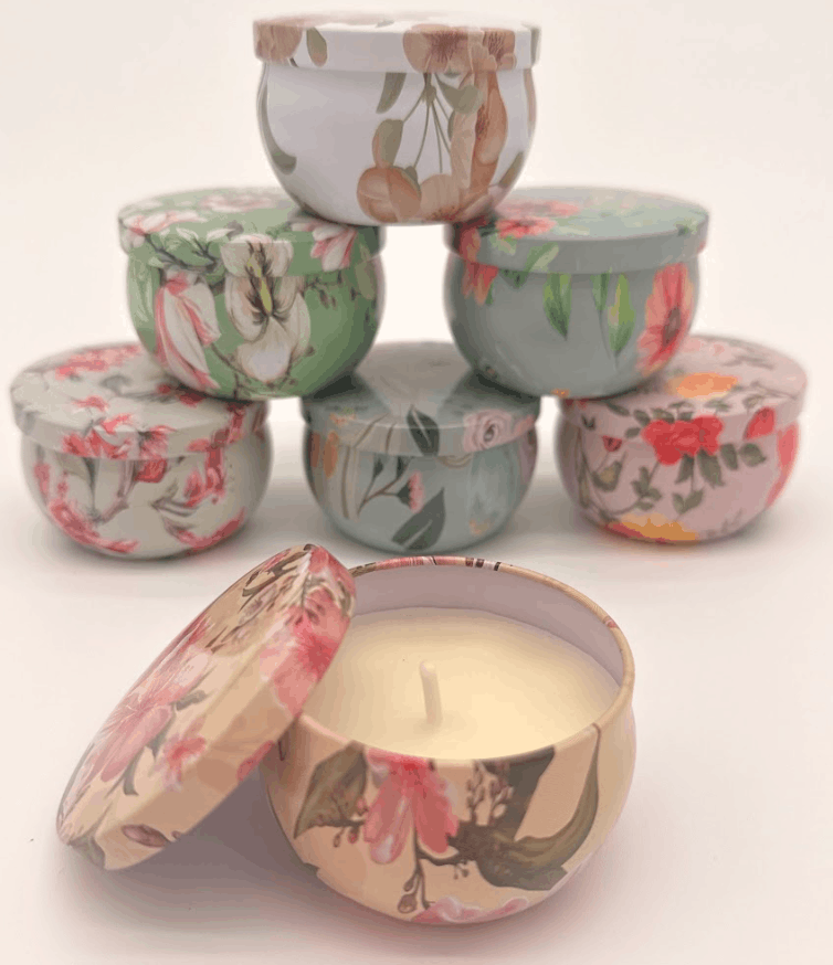 Three floral-patterned containers stacked on a beige surface with a white background