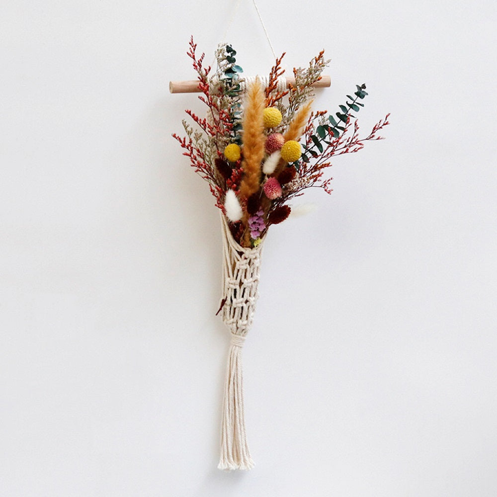 Bouquet of dried flowers in a woven cone on a white background